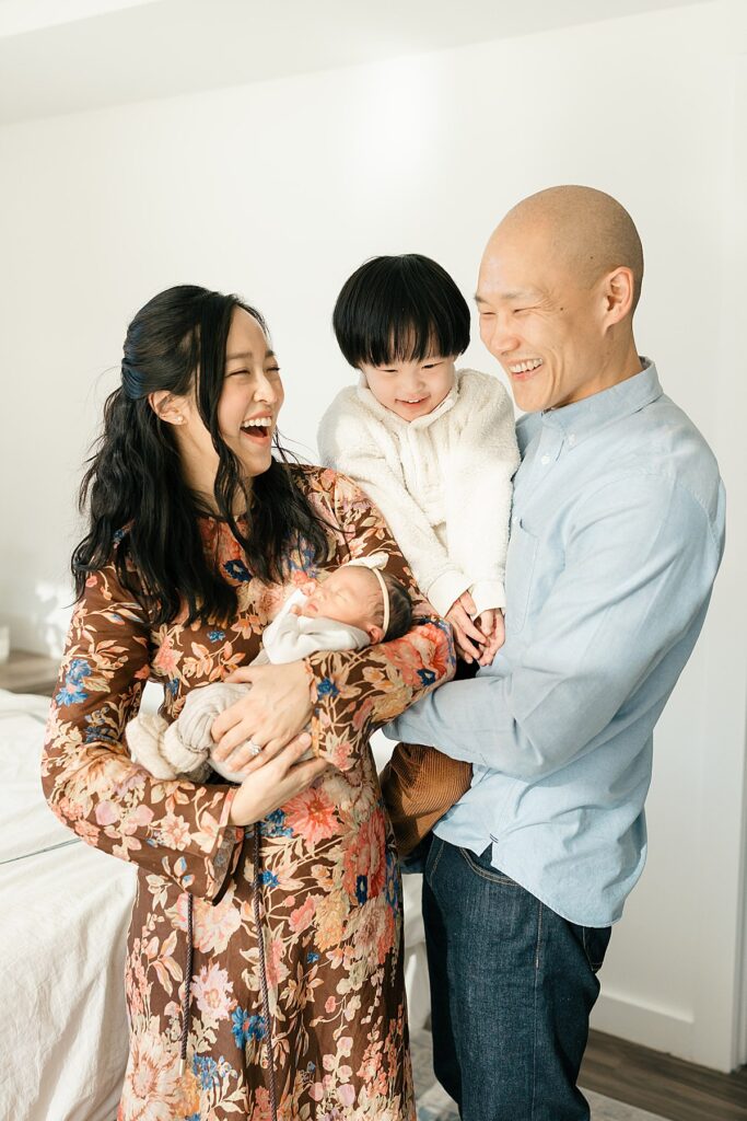 Photo of mother, father, toddler, and newborn baby by Hoboken newborn photographer, Christina Claire Photography