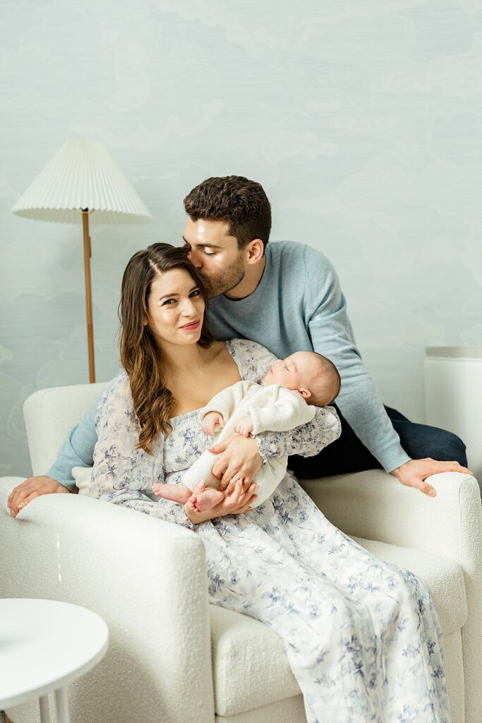 Image of mother sitting in rocking chair with newborn baby boy