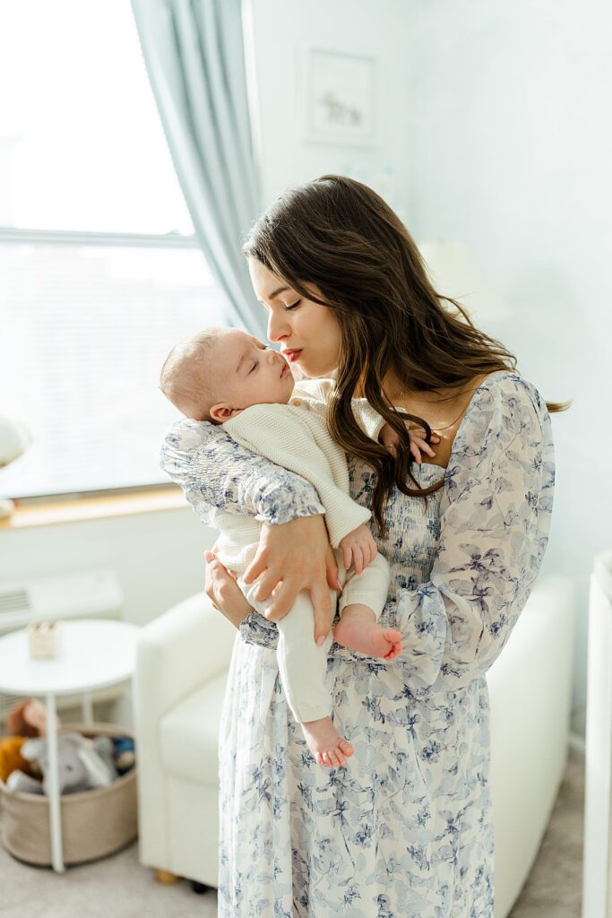 Image of mother kissing newborn baby boy, taken by Bergen County Newborn Photographer, Christina Claire Photography